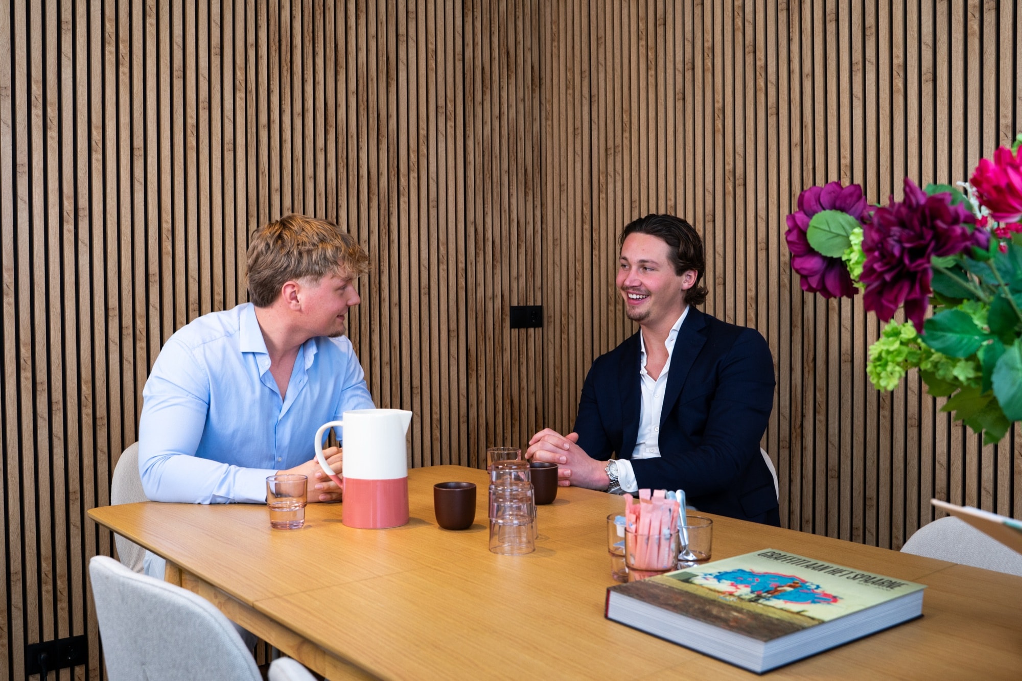 Abe and Binck in conversation at the meeting table